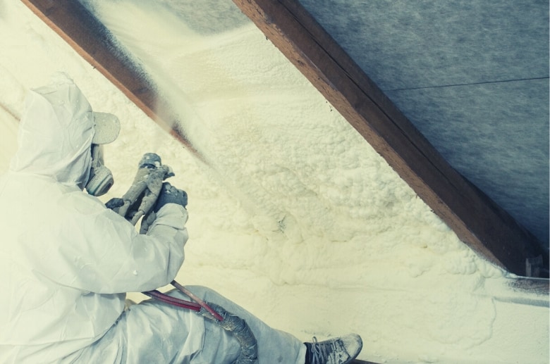 A spray-foam is being applied as insulation for garage ceiling.
