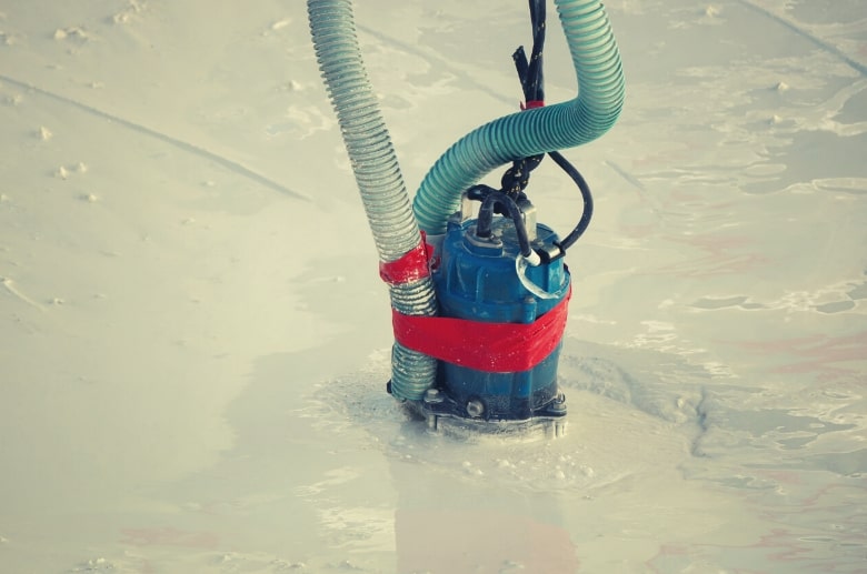 A sump pump can help in removing water in garage after heavy rain.