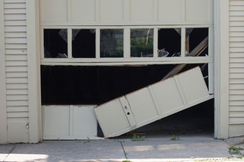 garage door is damaged because driver accidentally backed into garage door