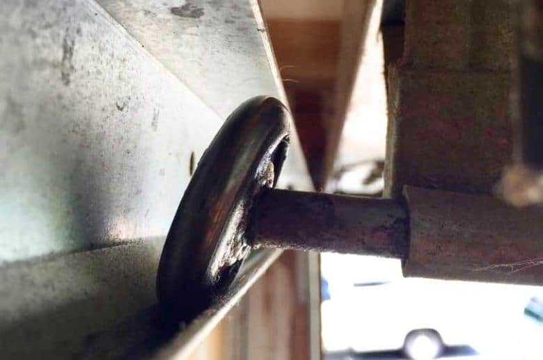 This is a rusted and bent garage door ball bearing rollers.