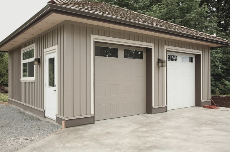 A detached garage with two garage doors. The detached garage meaning it is separate from the house or building.