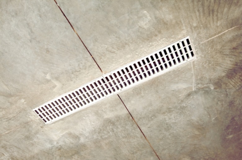 A floor drain. A floor drain is a must when you have an indoor hot tub in garage.