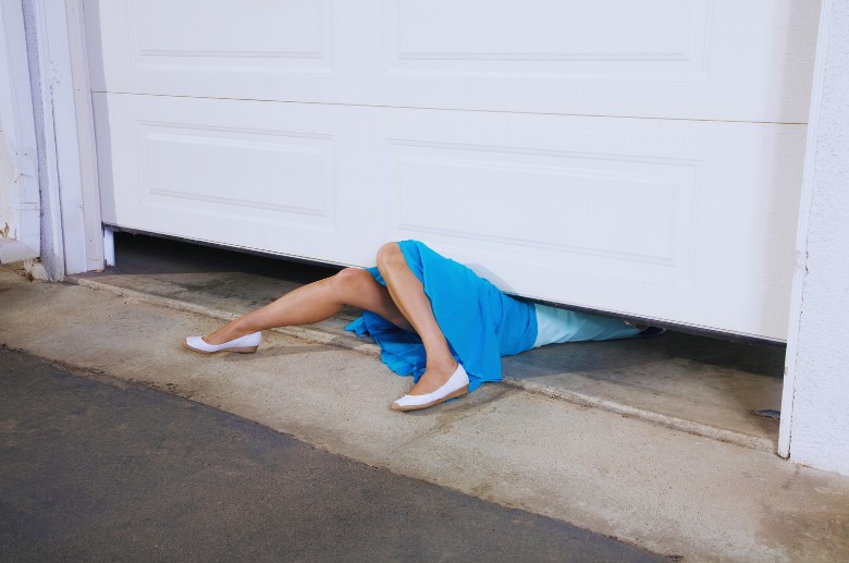 A woman in an accident. A garage door inspection must be done to avoid this.
