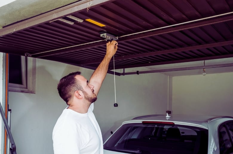 A man inspecting the garage door.