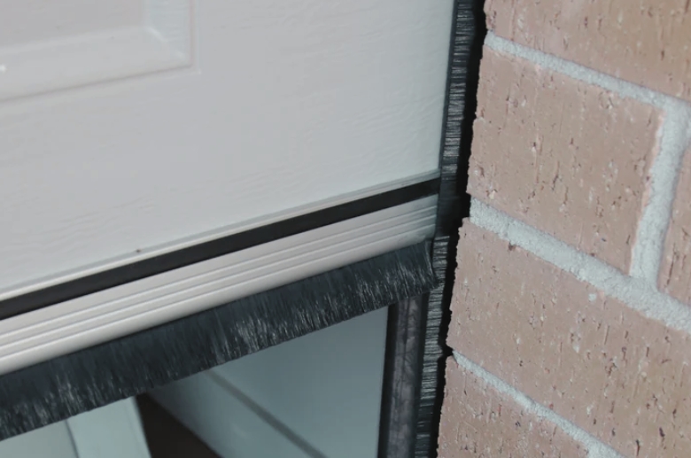 A brush seal for a garage door.