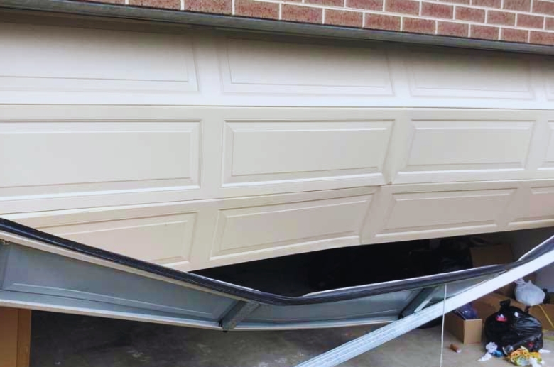 A damaged garage door due to the vehicle.
