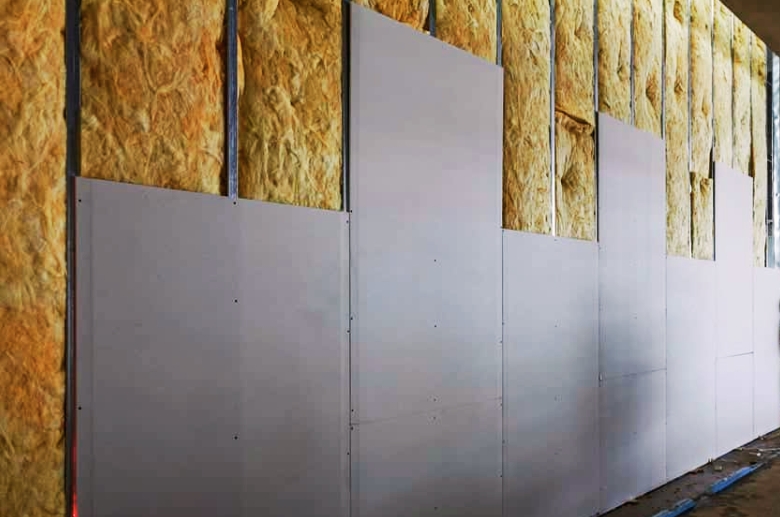 A garage door wall with noise insulating material.