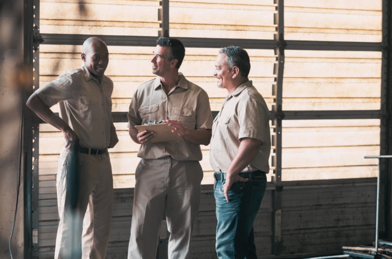 Garage door technicians discussing about an issue.