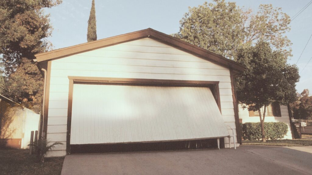 A garage door that is in the middle of opening. Know what to do when a garage door opens and closes by itself.