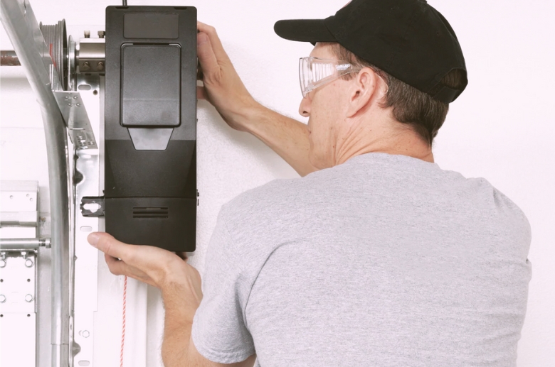 A professional installing a jackshaft garage door opener.