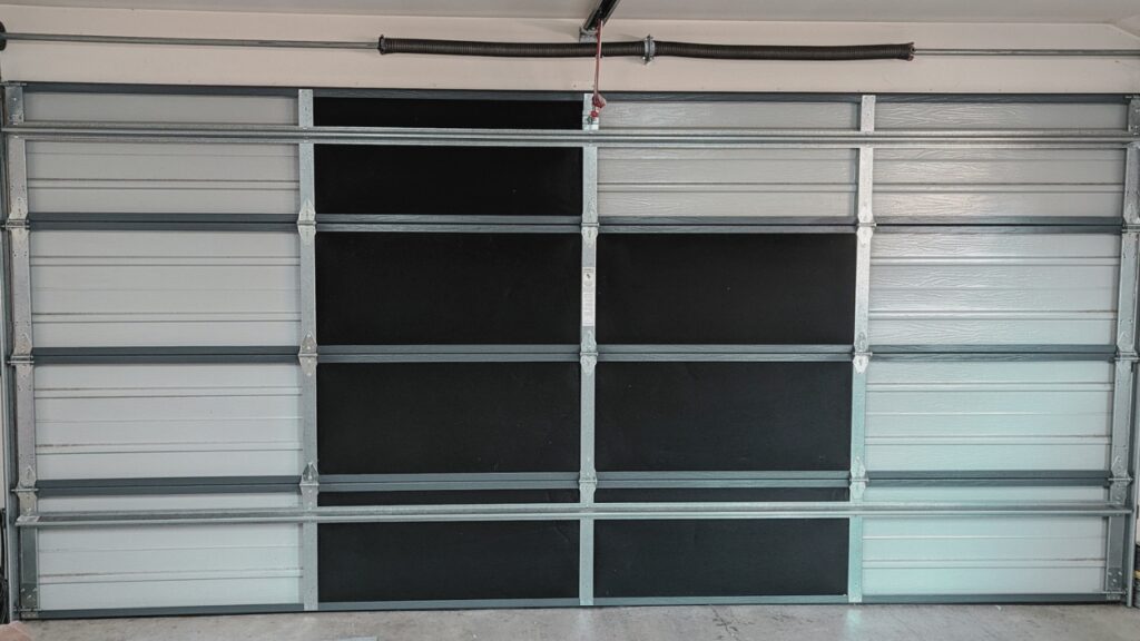 A garage door with some insulation panels. Know about the best garage door insulation.