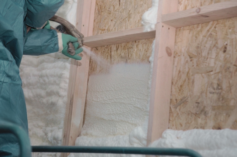 A man spraying Polyurethane foam insulation.